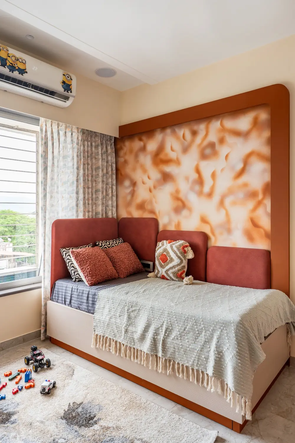 Child's bedroom with an abstract terracotta feature wall